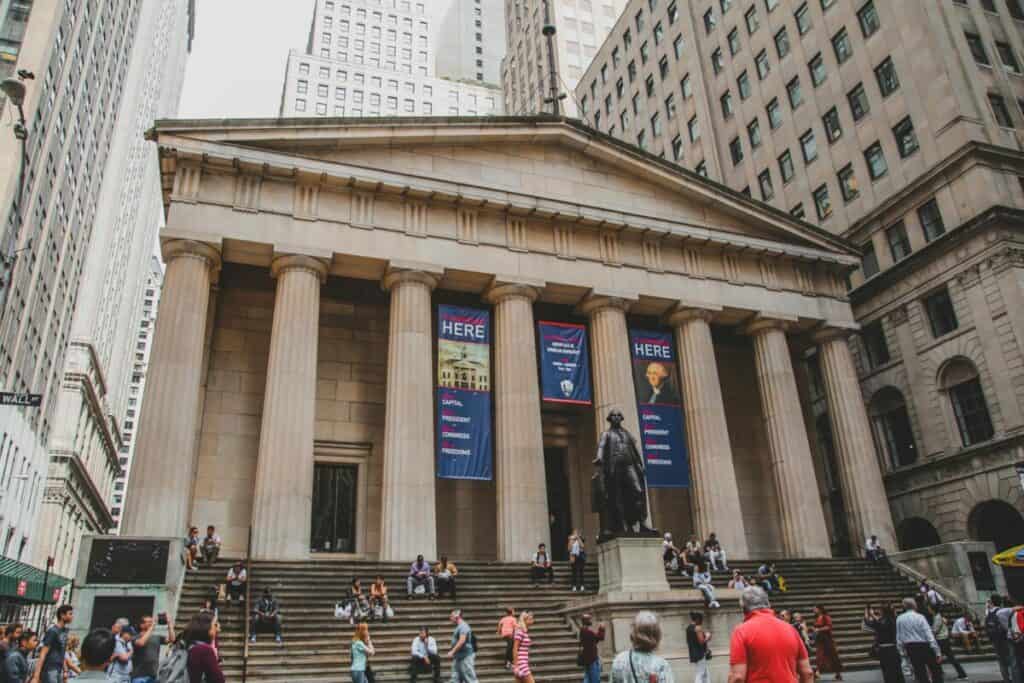View of Federal Hall with George Washington statue and people in NYC