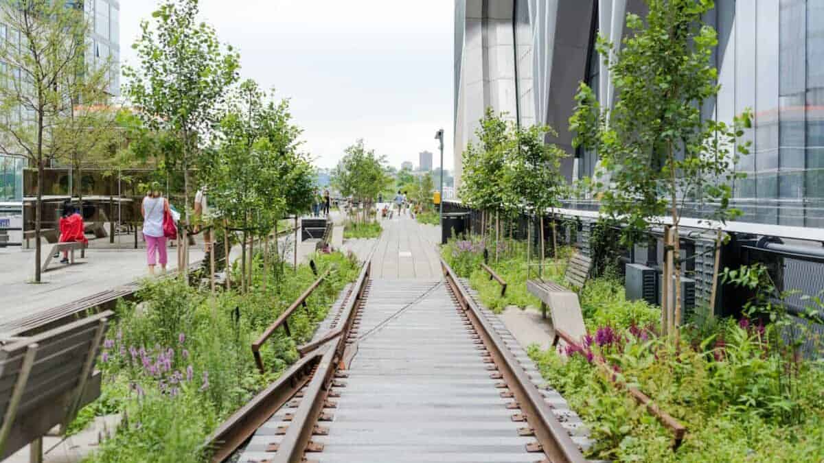 people walking on gray concrete pathway during daytime, High Line park in NYC