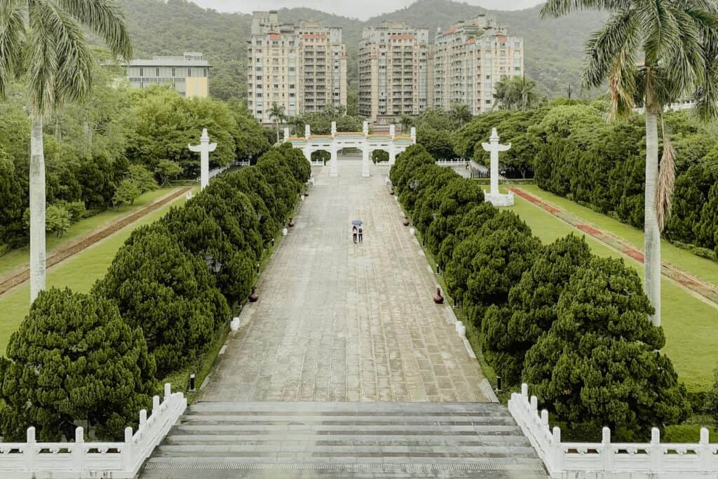 view from National Palace Museum | gray concrete pathway between green trees and plants during daytime