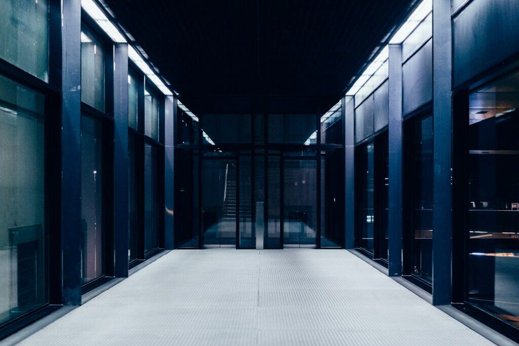 Museo Reina Sofía | a long hallway with glass doors leading to another room